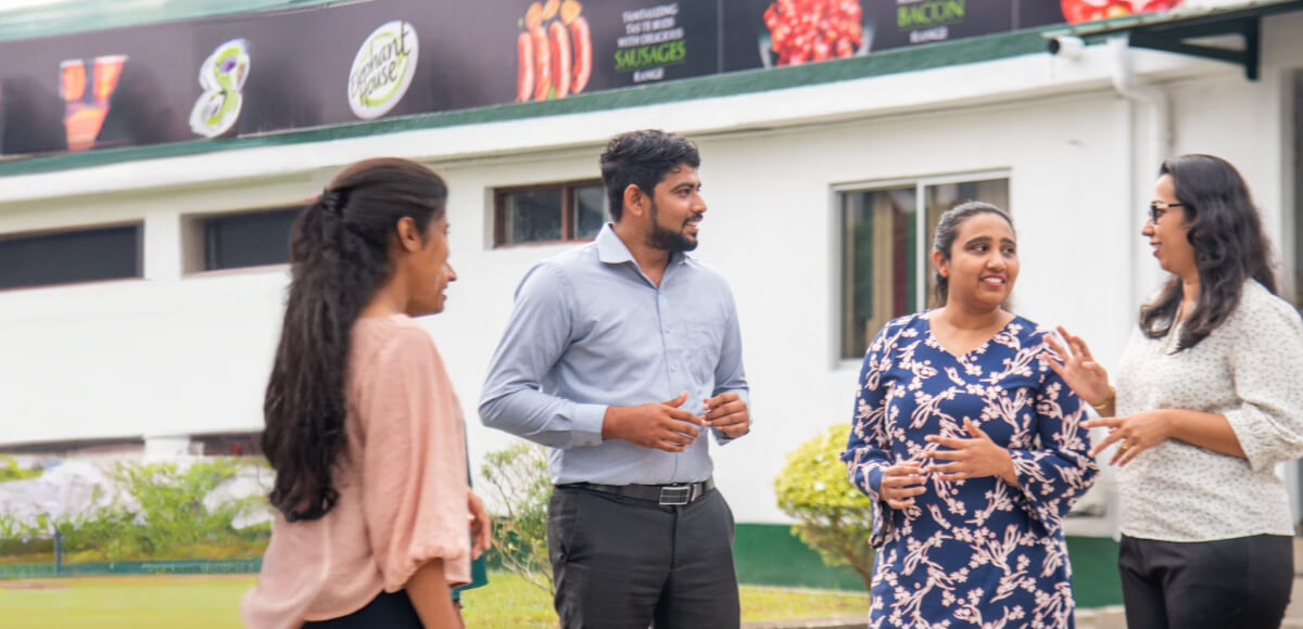 Group of members discussing in front of office 